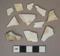 Undecorated whiteware vessel body and rim fragments, white paste