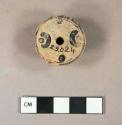 Pottery spindle whorl + colomn