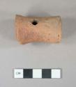 Ceramic leg to a vessel, perforated, hollow, red.