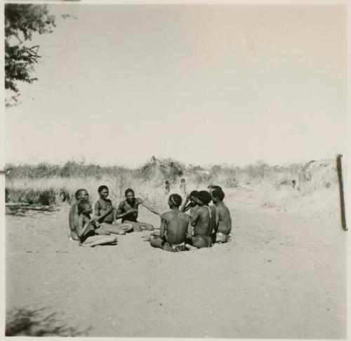 Men and boys playing !ó'm!hú /!’Om g!xuni / ’Ai kota !U!u g!xuni / N!aih //’an (the porcupine game, also known as the axe game, assegai game or war game)