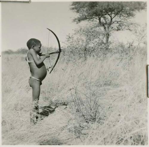 Boy shooting with a bow and arrow