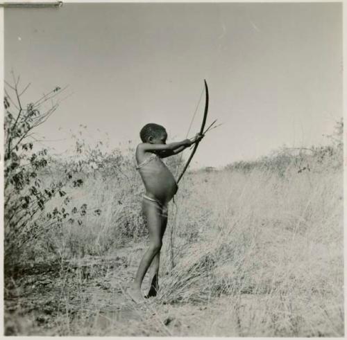 Boy shooting with a bow and arrow