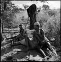 Two boys playing, with a girl sitting next to them watching, John Marshall filming them