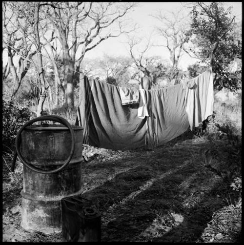 Expedition member bathing behind a curtain of blankets