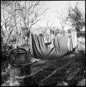 Expedition member bathing behind a curtain of blankets