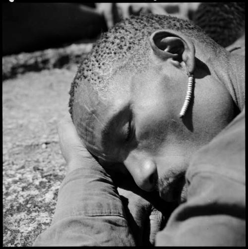 Man wearing an earring, sleeping, close-up of his head