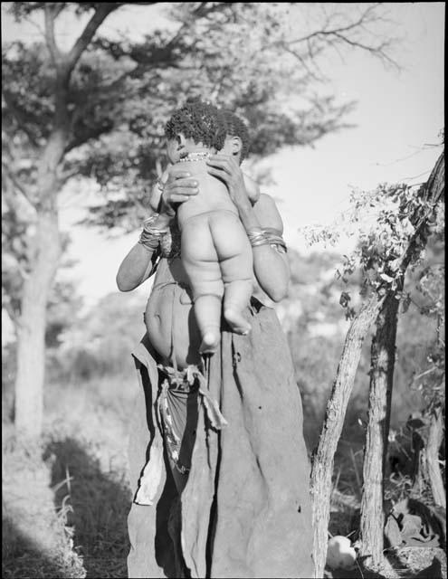 Woman standing and holding a baby