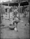 Makiena pouring milk from a calabash into a bowl