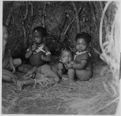 Children sitting inside a skerm