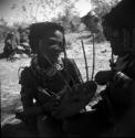 Girl playing the //guashi, sitting with another girl