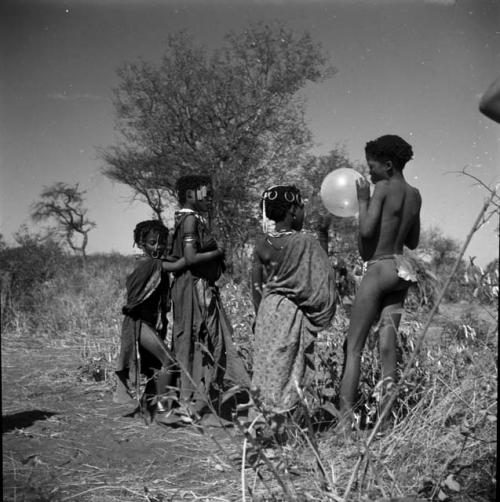 Group of children with a balloon given to them by Anneliese Scherz