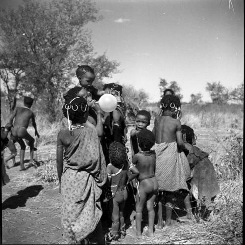 Group of children with a balloon given to them by Anneliese Scherz