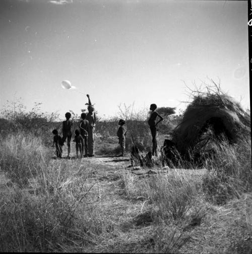 Group of children tossing a balloon given to them by Anneliese Scherz