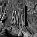 Quiver with contents laid out on a kaross, including arrow shafts without points, "male" and "female" fire-sticks, two drills, two long arrows with unbarbed points, an arrow-shaft, and six arrows with metal points