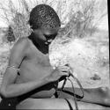 Gau's son holding a slingshot made from a piece of an old inner tube