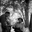 ≠Toma wearing Western clothing, standing with Venter, with John Marshall filming behind them