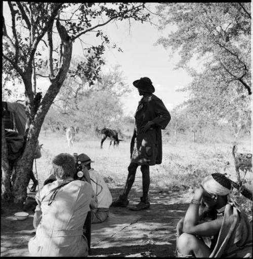 John Marshall filming two kudus in the veld, view from behind, with a woman sitting, Venter standing near him