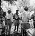 Group of men standing, talking