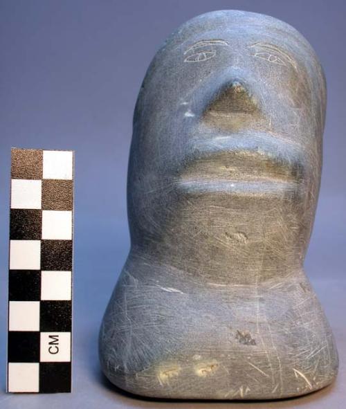 Stone carving of head of man by Arnaksanguark