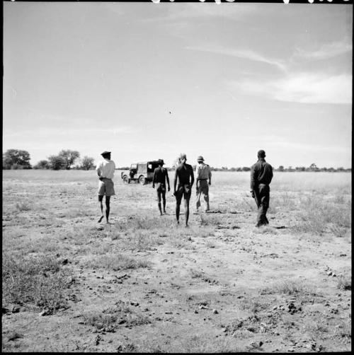 Men walking toward the expedition Jeep