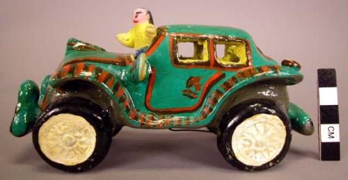 Ceramic model car figurine with driver