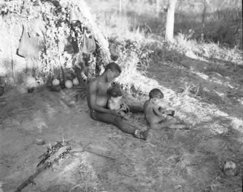 Man sitting with two children