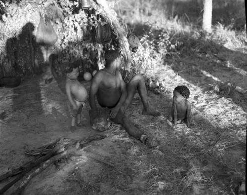 Man sitting with two children