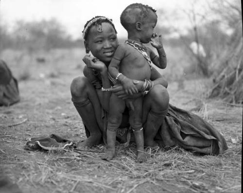 Wife of Gao (brother of Gau) sitting, holding her little boy