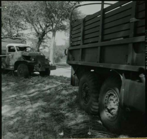 Expedition truck pulling another truck by a rope, view from the side