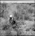 ≠Nisa digging with her digging stick, distant view