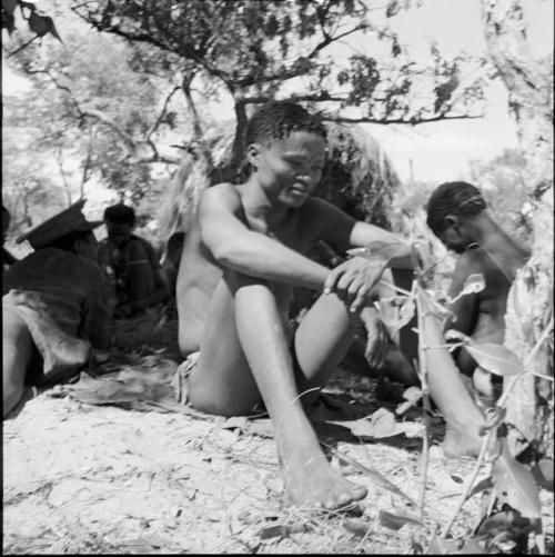 Man sitting, with his arms resting on his knees