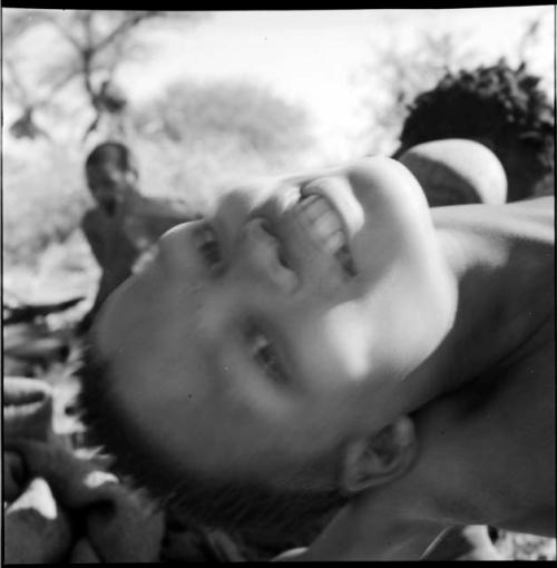 Boy leaning backwards, close-up of his face