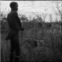 Bojo standing near a dead animal, holding his assegai