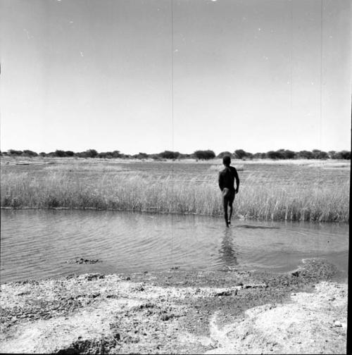 Man walking in the water in a pan, distant view