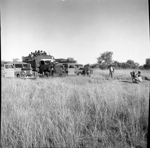 Group of people in the back of one of the expedition trucks, parked between two other expedition vehicles