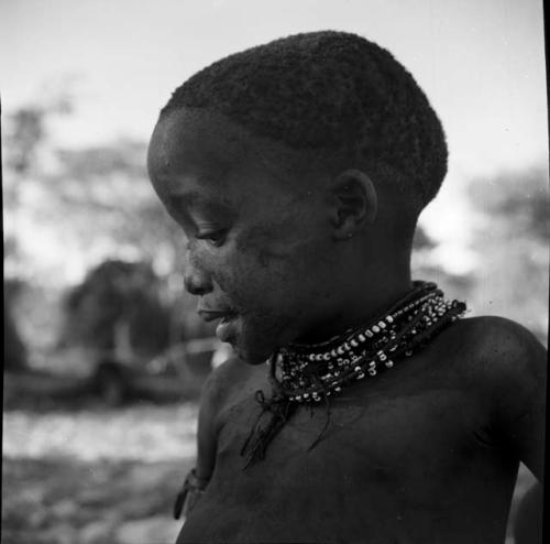 Child wearing necklaces, portrait