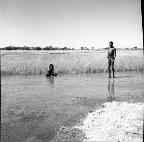 "Gao Medicine" standing in a pan, with a man sitting in the water, bathing near him