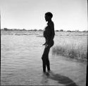 Man standing in the water in a pan, profile