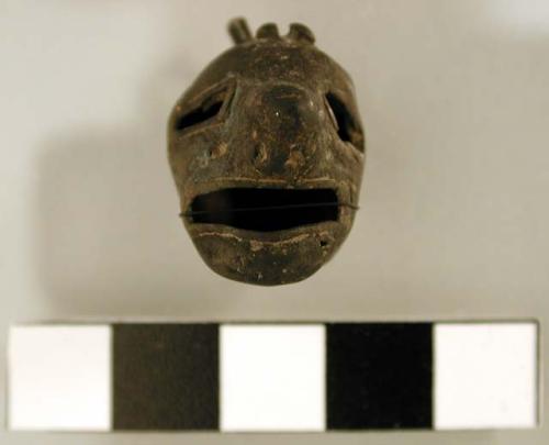 Metal bell, human head