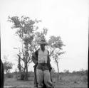 Man from Kubi standing, smoking a pipe