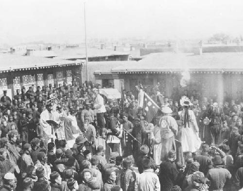 Crowd in courtyard, with banners