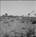 John Marshall filming, view from behind, with skerms in the distance