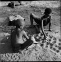 Two boys playing /Ui (the counting game), view from above
