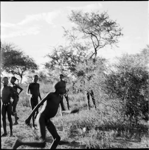 Boys playing a stick-throwing game (out of focus)