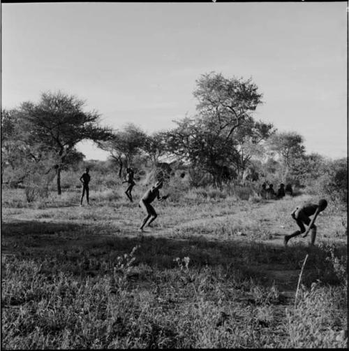 Boys playing a stick-throwing game