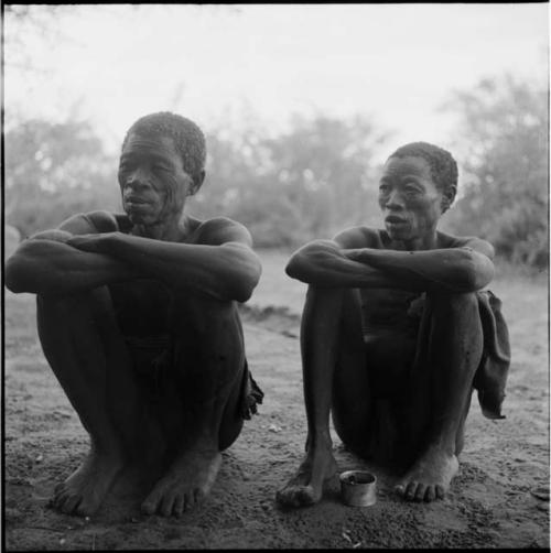 Gau sitting with another man, talking