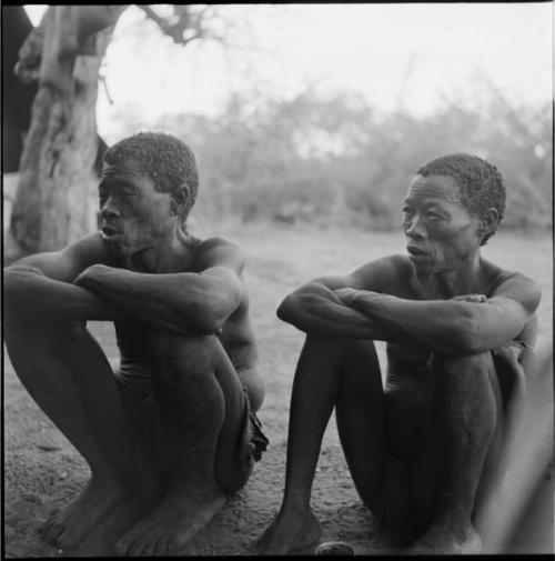 Gau sitting with another man, talking