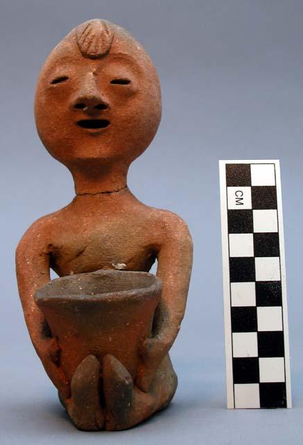 Figurine, micaceous ceramic, seated human w/ pot in lap, mended