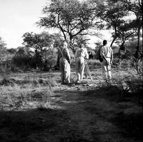 People standing next to skerms, with Laurence Marshall, John Marshall and another expedition member filming them