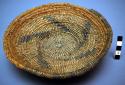 Small basket tray, coiled. Made of devil's claw and bear grass.